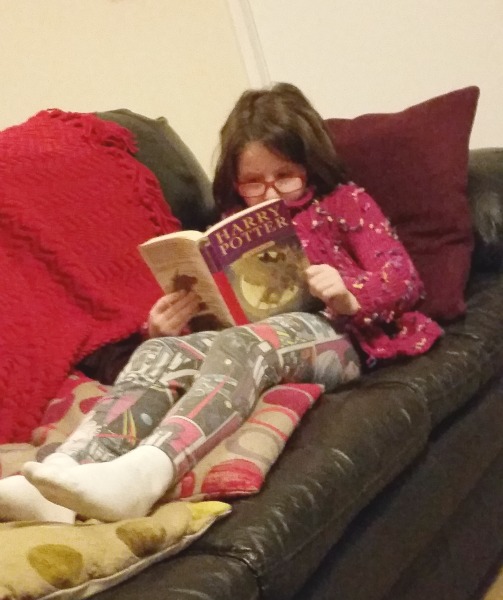 H reading Harry Potter