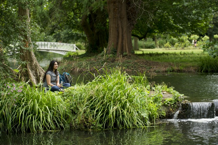 Woman relaxing beside the River Wandle at Morden Hall Park, London. ©National Trust Images John Millar