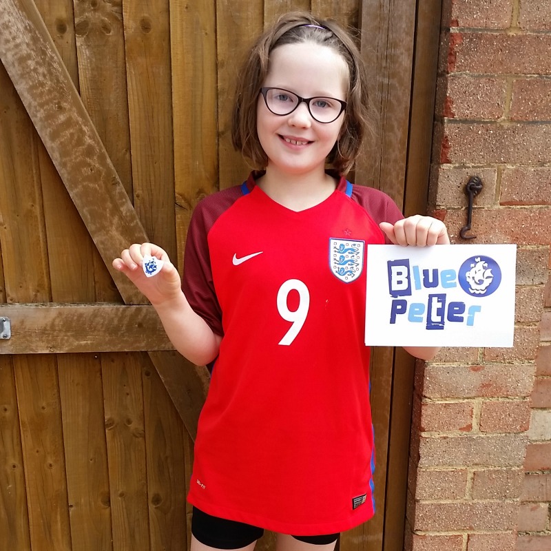 H earns her first Blue Peter badge