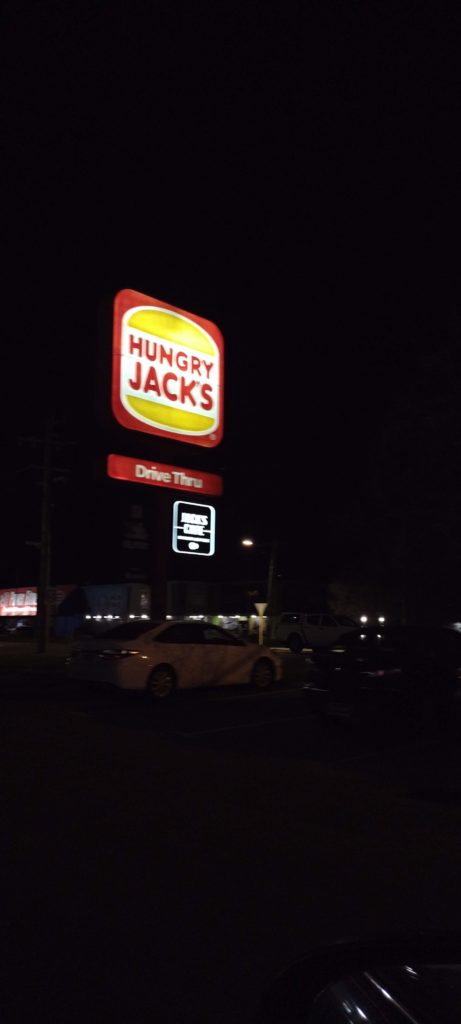 Hungry Jack's just outside Perth, Western Australia. Drive Thru sign lit up against the night sky. 